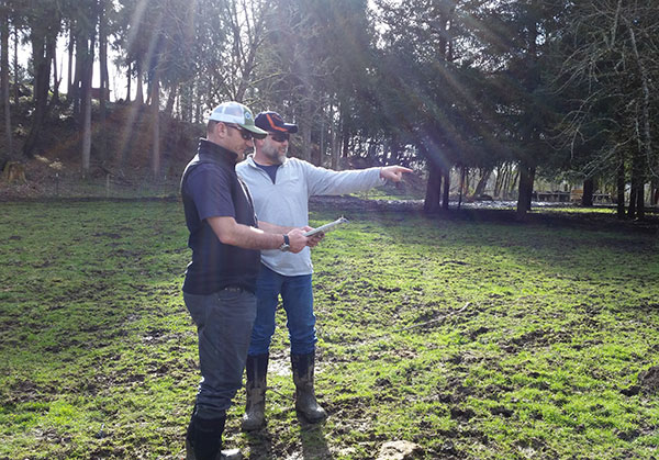 Jeremy and a landowner discussing pasture management