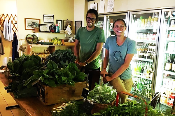 Brindley and Spencer of Tanager Farm selling their CSA shares at a neighborhood market