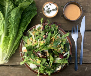 greens and a salad dressing
