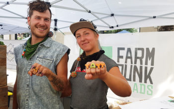 Quinn and Theus of Farm Punk Salads pose at their booth