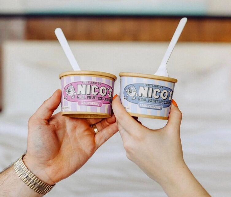 Two people doing cheers with two cups of ice cream