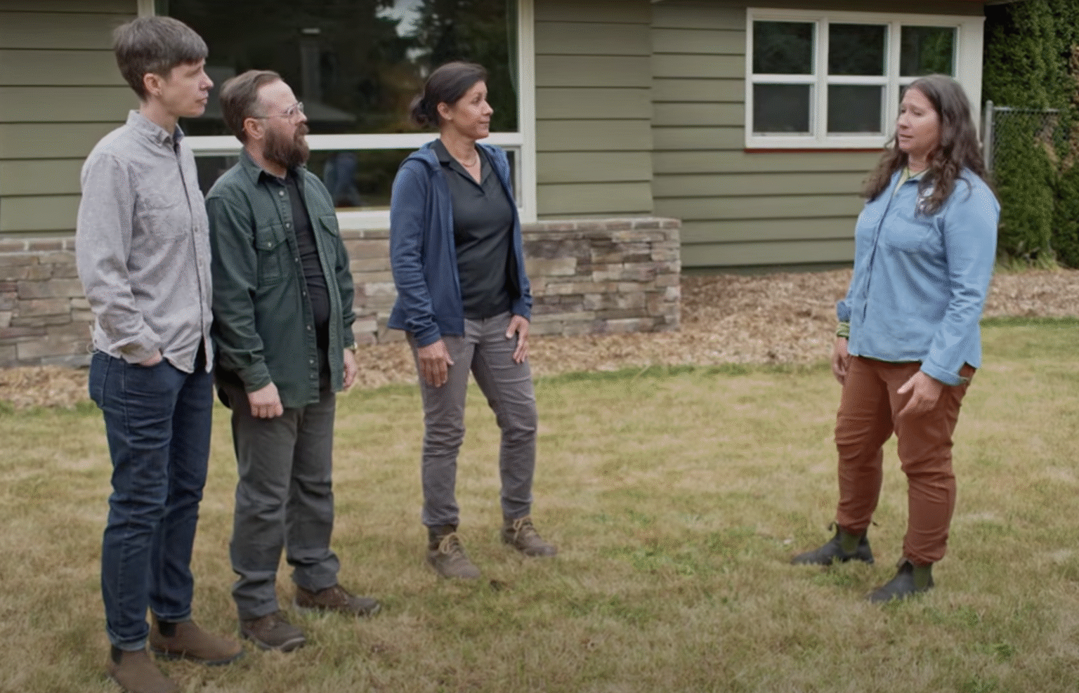 Still video shot of EMSWCD staff talking with This Old House producers in front of a home, getting ready to build a rain garden.