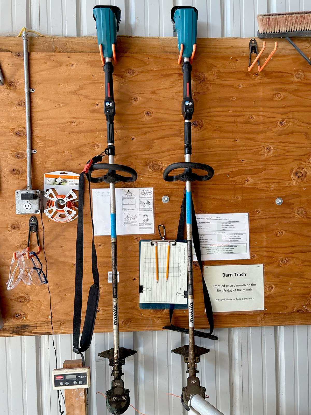 photo of string trimmer tools mounted on a wall